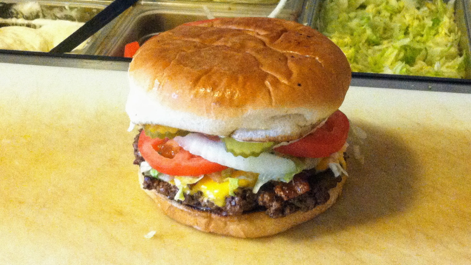 Loaded cheeseburger with lettuce, tomato and onion at Jay & Diane's Horseshoe Grill